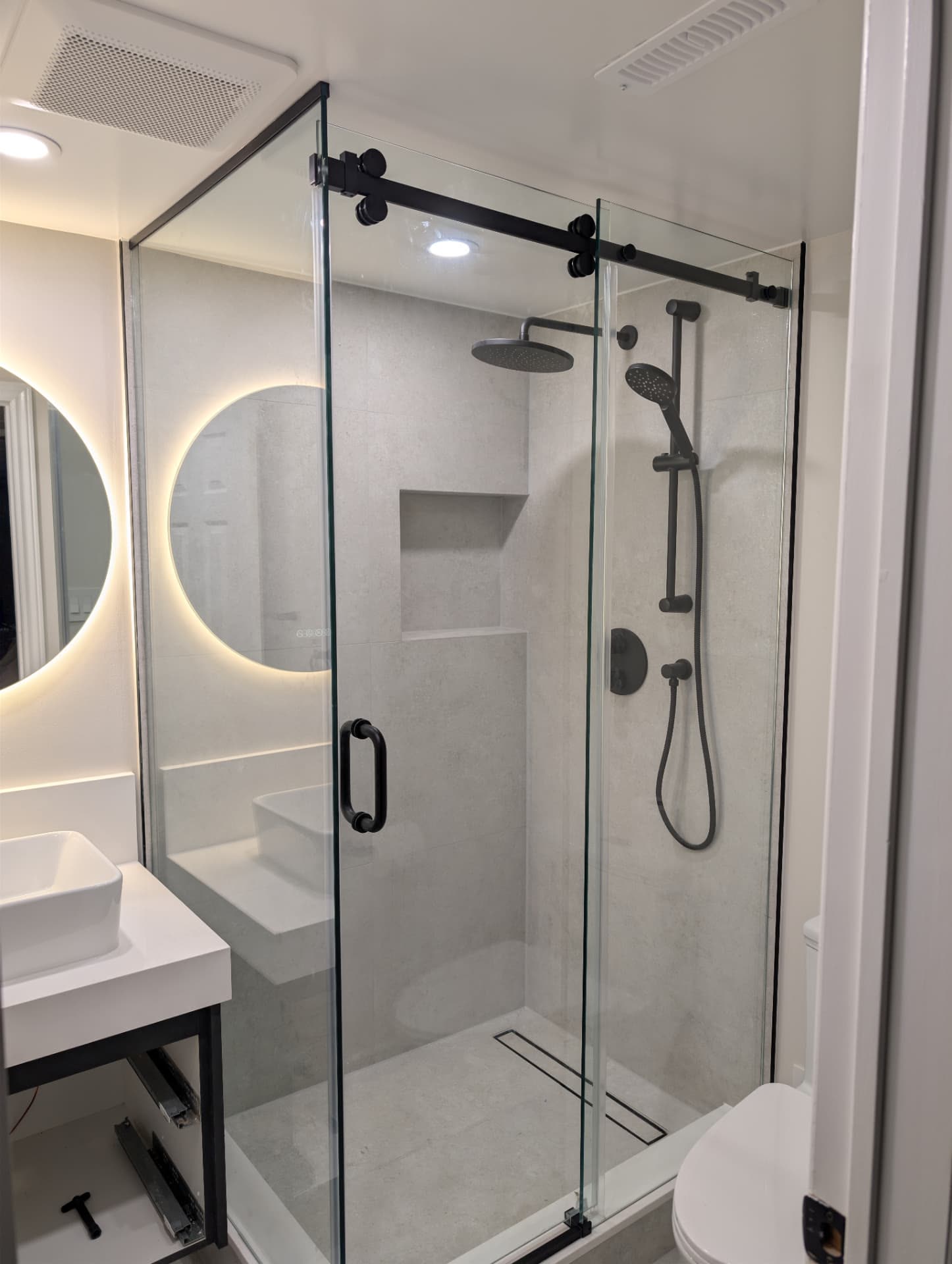 Frameless sliding glass shower enclosure installed by YZ Glass Expert
